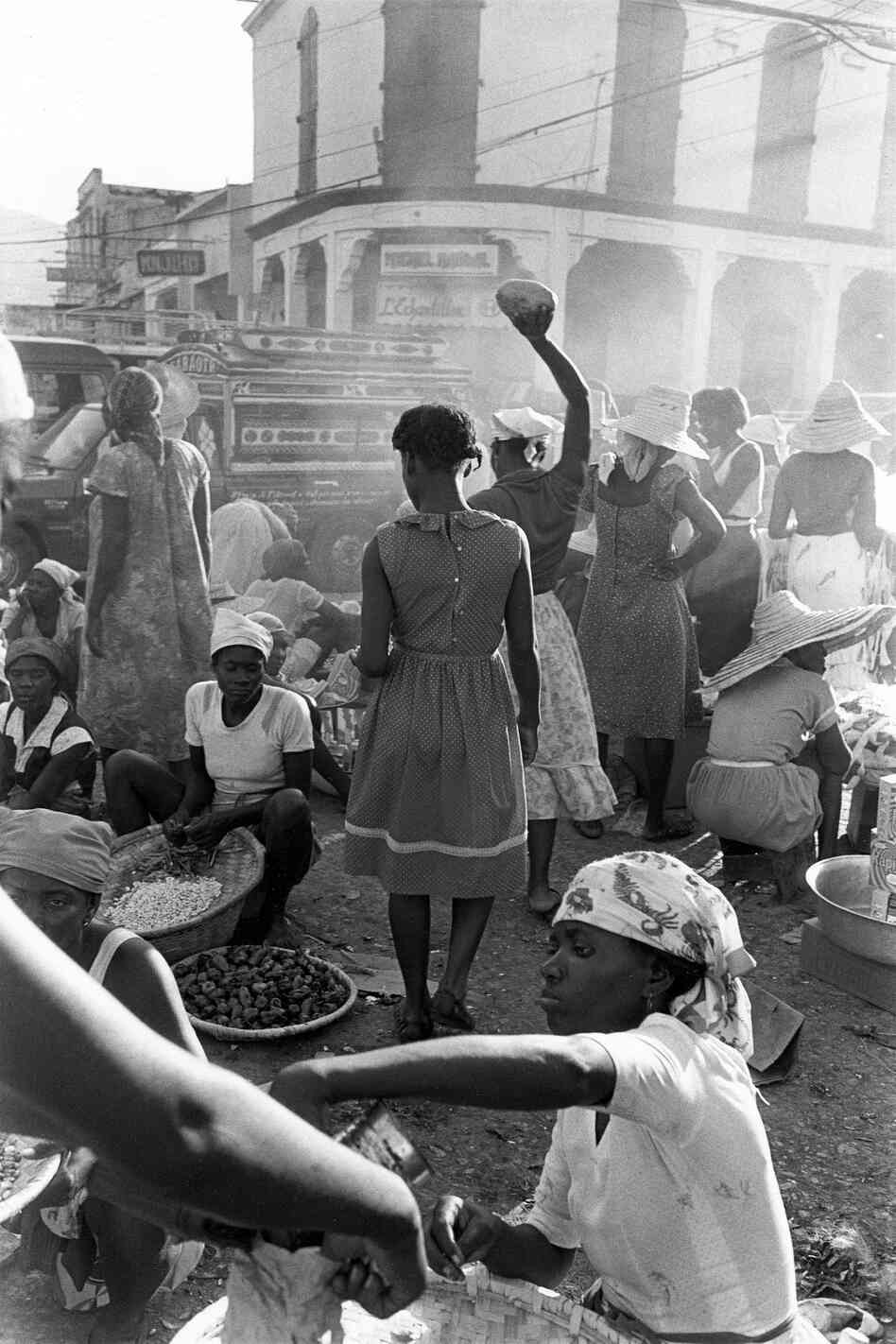 Woman lifting fruit on downtown street, Port-au-Prince, Haiti, 1985