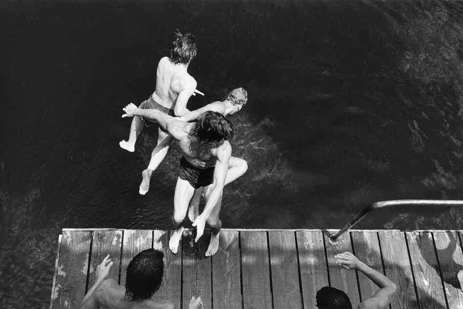Three boys jumping off diving platform, Wakulla Springs, Fla., 1980
