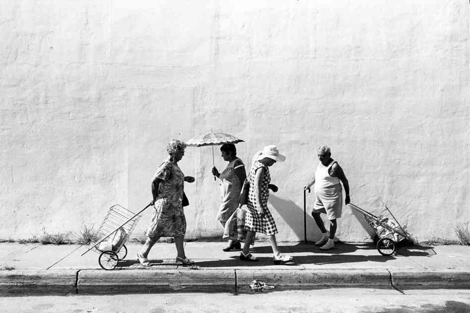 Four people on sidewalk at Sixth Street, South Beach, Miami Beach, 1978