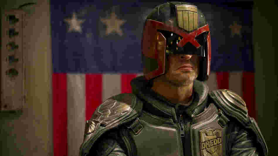 Judge Dredd (Karl Urban) is responsible for both convicting and punishing the criminals of Mega-City One. Judge Dredd (Karl Urban) is responsible for both convicting and punishing the criminals of Mega-City One.