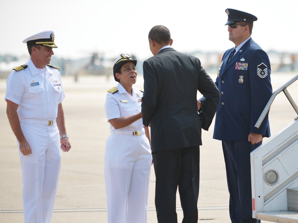 President Obama is greeted by naval officers at Naval Air Station Norfolk, in Norfolk, Va., on Sept. 4.