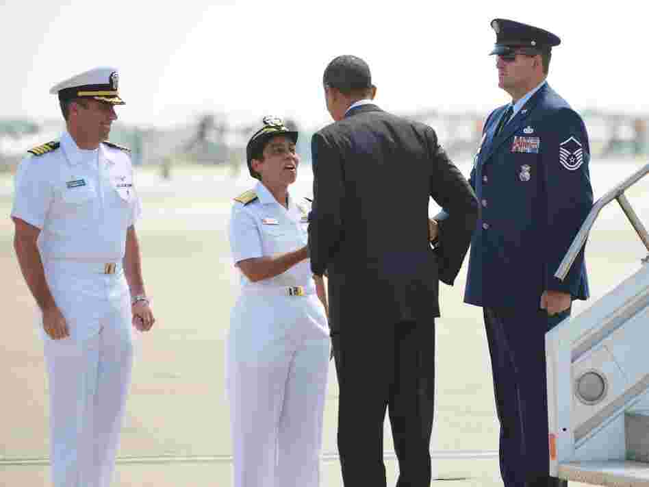 President Obama is greeted by naval officers at Naval Air Station Norfolk, in Norfolk, Va., on Sept. 4.