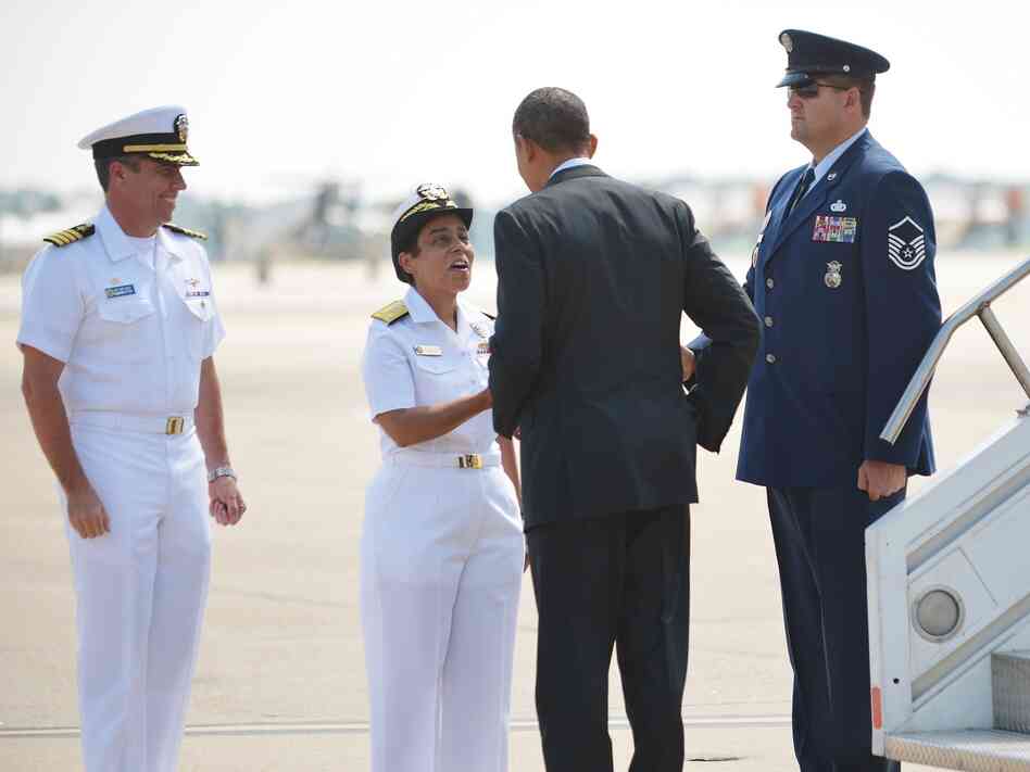 President Obama is greeted by naval officers at Naval Air Station Norfolk, in Norfolk, Va., on Sept. 4.