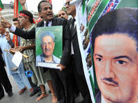 Pakistani lawyers carry posters of Khan at a rally in support of him in Lahore in 2008.