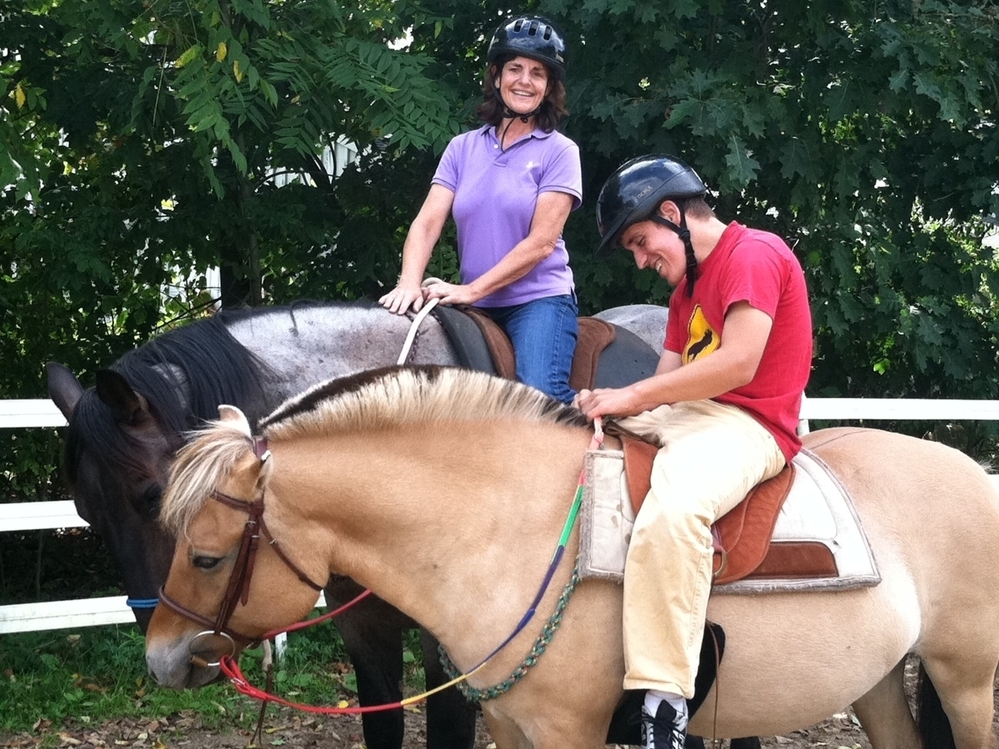 Andy Tranfaglia, 23, who has Fragile X syndrome, rides a horse with his mother, Katie Clapp.