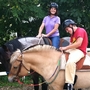 Andy Tranfaglia, 23, who has Fragile X syndrome, rides a horse with his mother, Katie Clapp.