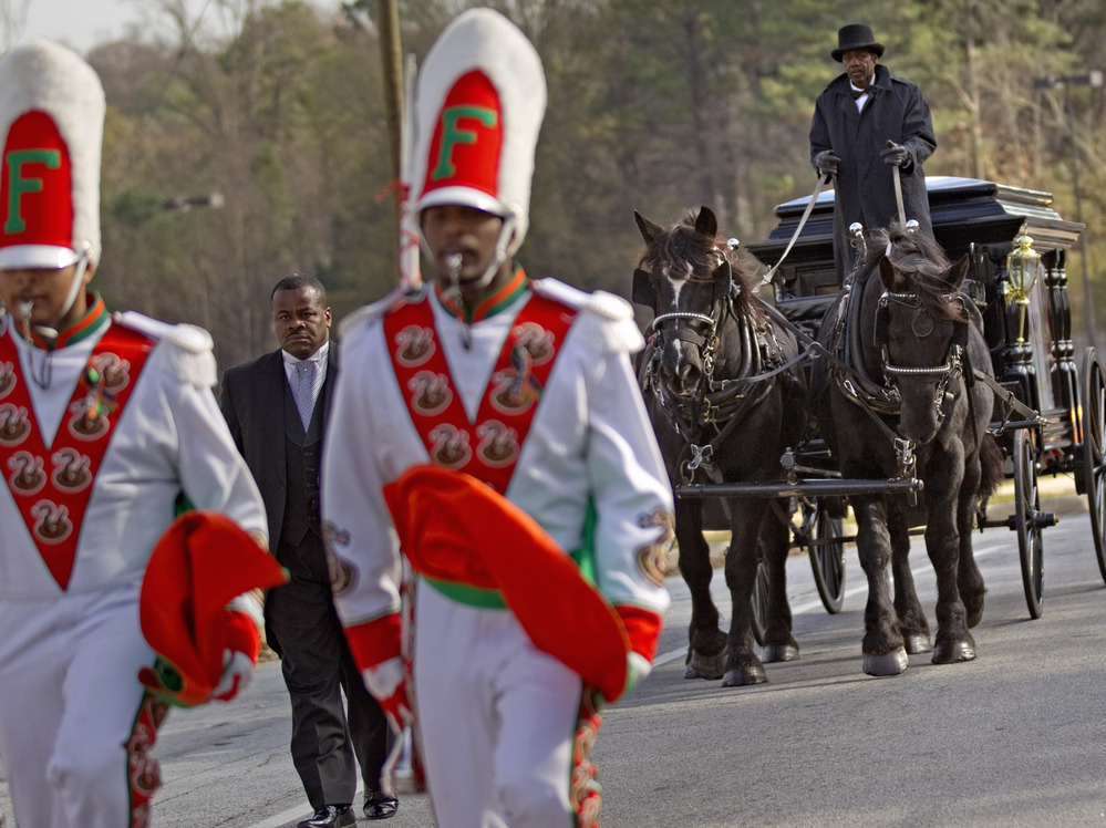 A horse-drawn carriage carrying the casket of Florida A&M University band member Robert Champion is led by his fellow band members following his funeral service in November.