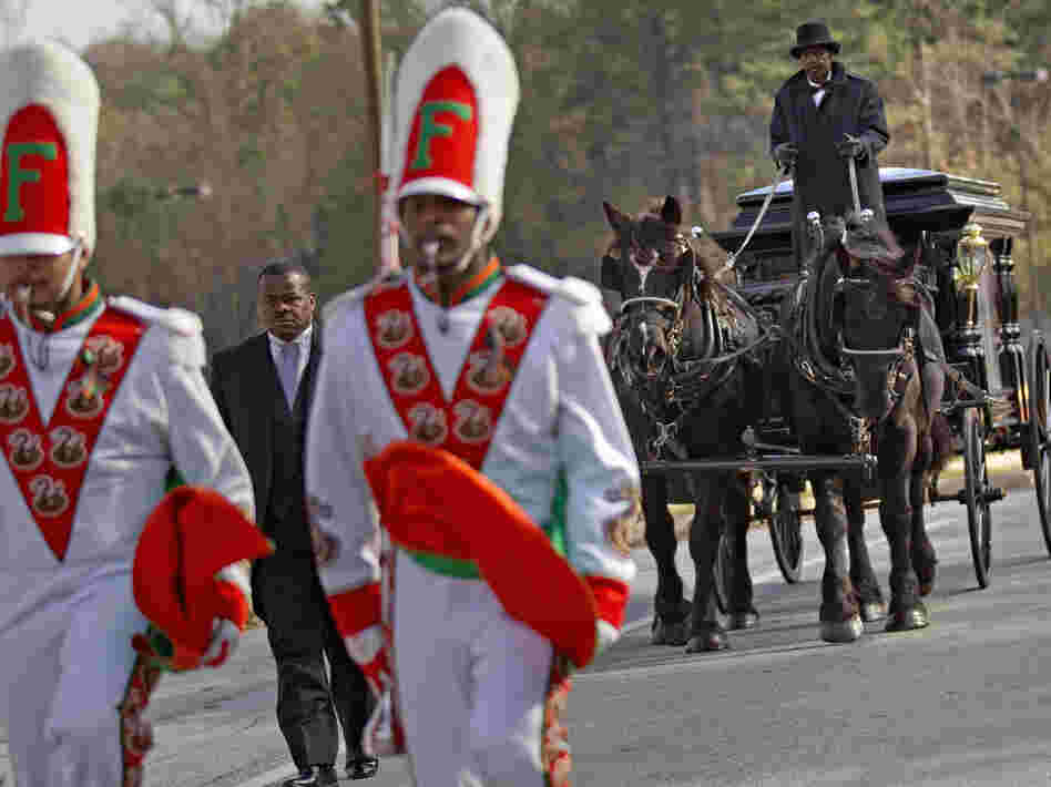 A horse-drawn carriage carrying the casket of Florida A&M University band member Robert Champion is led by his fellow band members following his funeral service in November.