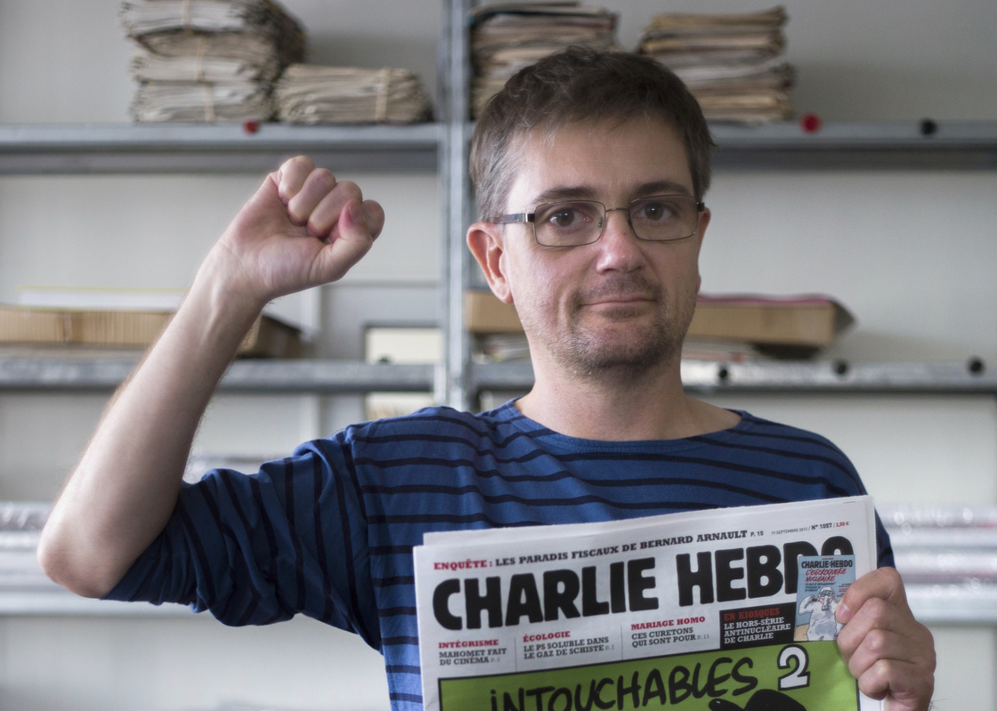 At the offices of the French satirical weekly Charlie Hebdo earlier today, publisher/editor Stephane Charbonnier ("Charb") struck a defiant pose.