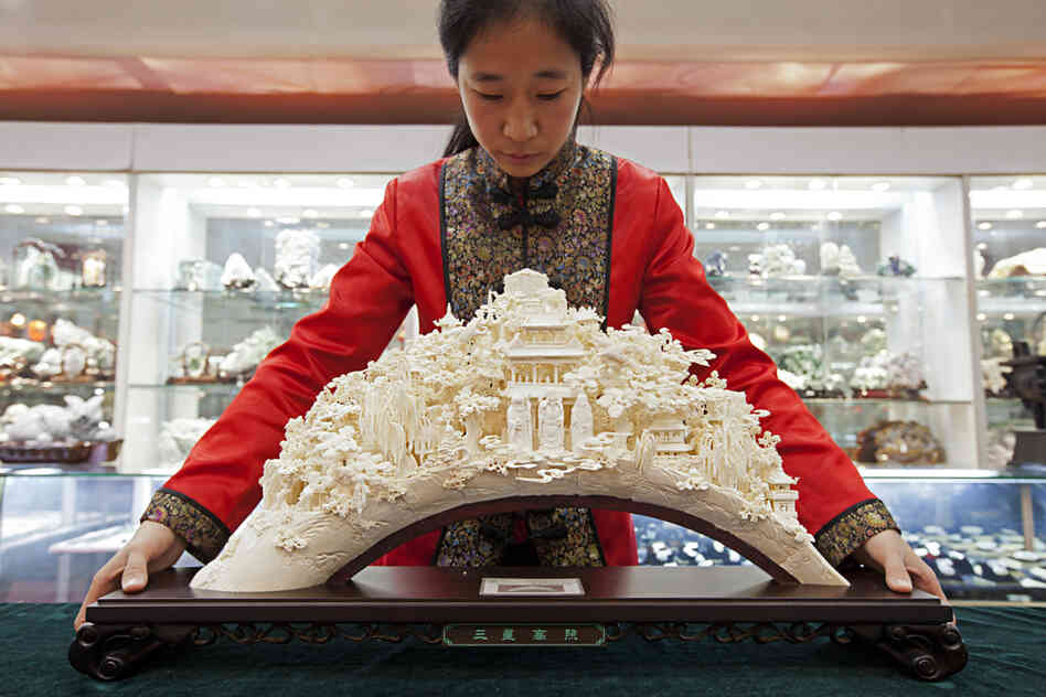 "A sculpture like this can take a master carver years to produce. Front and center are the popular Taoist gods Shou, Lu and Fu -- symbols of long life, money and luck. 'We hope -- no, we insist -- we can continue to protect these skills,' says Wang Shan, secretary-general of the China Arts and Crafts Association."
