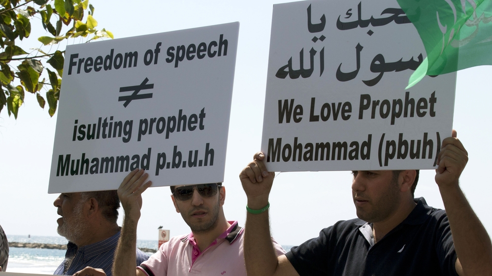 Arab-Israeli men protest a video mocking the Prophet Muhammad, in front of the U.S. Embassy in Tel Aviv, Israel, on Thursday.