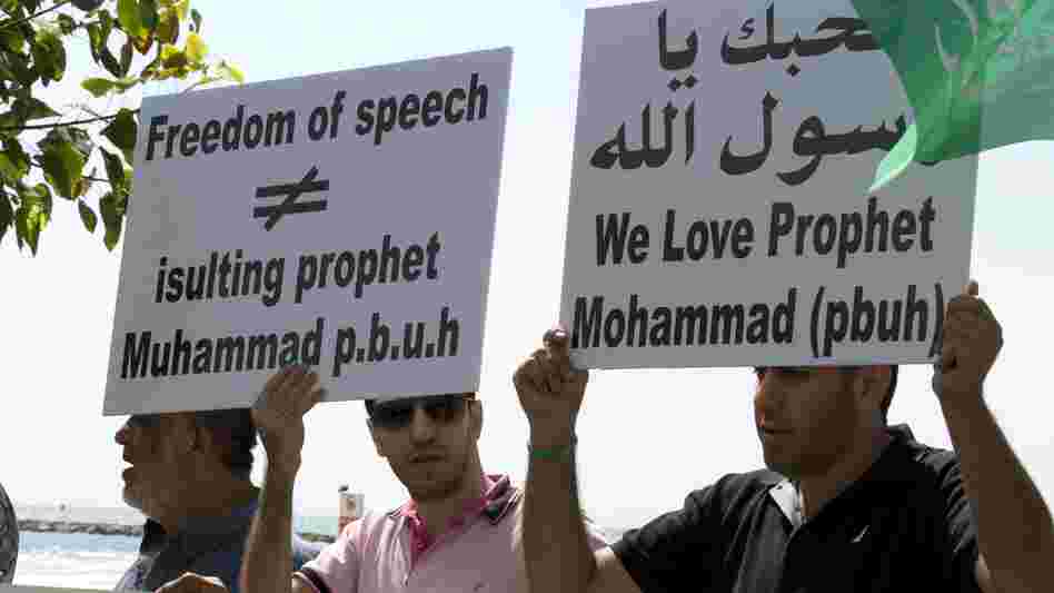 Arab-Israeli men protest a video mocking the Prophet Muhammad, in front of the U.S. Embassy in Tel Aviv, Israel, on Thursday.