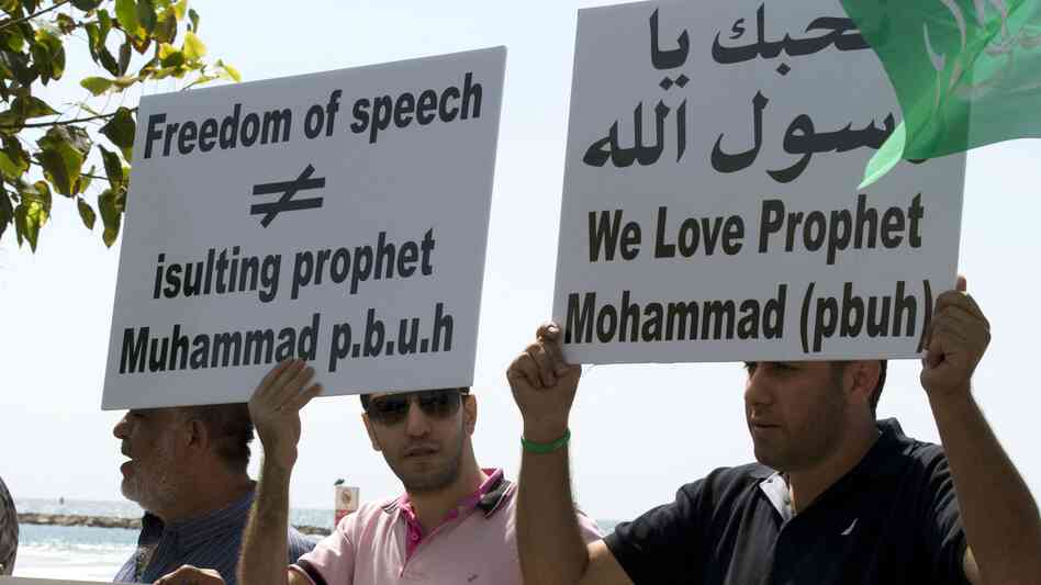 Arab-Israeli men protest a video mocking the Prophet Muhammad, in front of the U.S. Embassy in Tel Aviv, Israel, on Thursday.