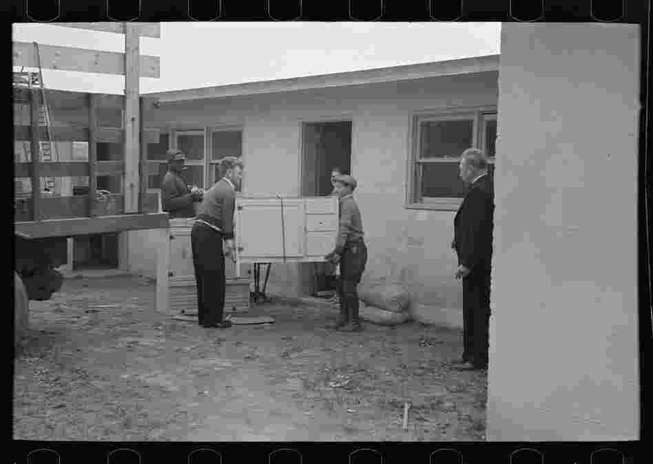 Abe Lipsky, the farm foreman, moves into his home after living in temporary quarters for more than a year. One argument for why the cooperative businesses failed is that they were expected to be productive before the town was fully settled.