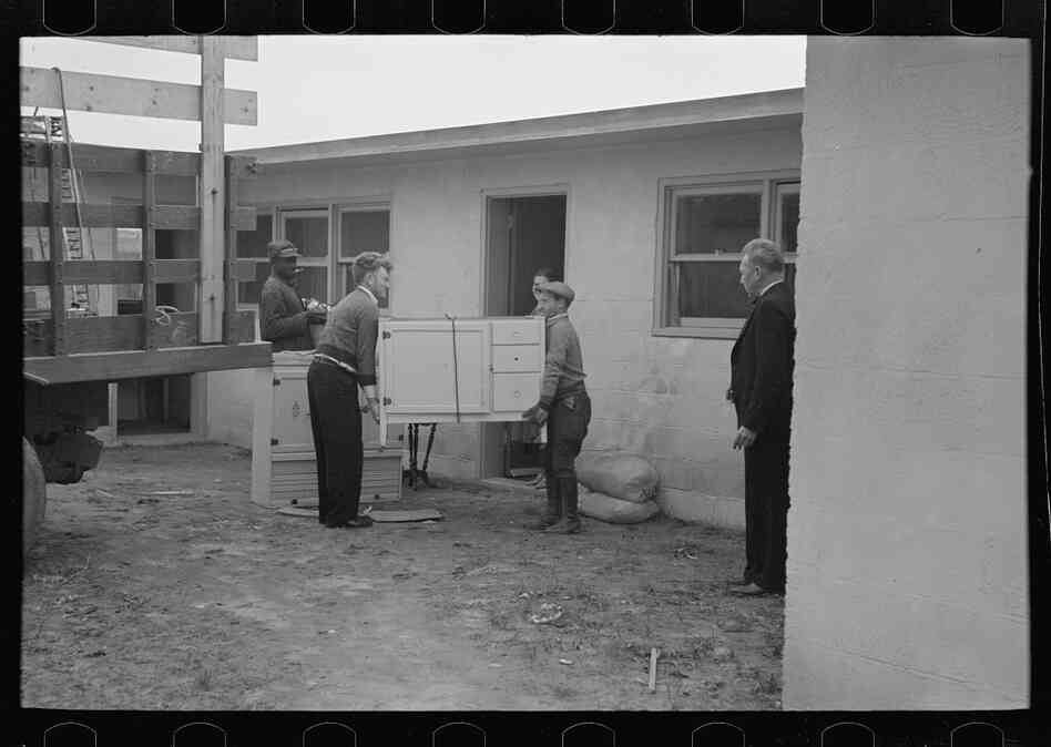 Abe Lipsky, the farm foreman, moves into his home after living in temporary quarters for more than a year. One argument for why the cooperative businesses failed is that they were expected to be productive before the town was fully settled.