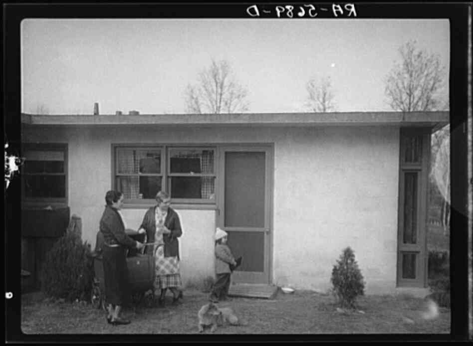 Outside one of the new cooperative houses. They were designed in part by now-renowned architect Louis Kahn. At the time, Kahn was a young assistant.
