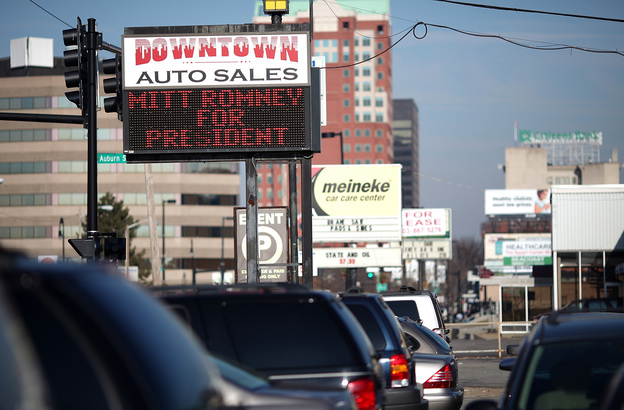 A used-car lot displays a sign in support of Republican presidential candidate Mitt Romney in Manchester, N.H., in January.