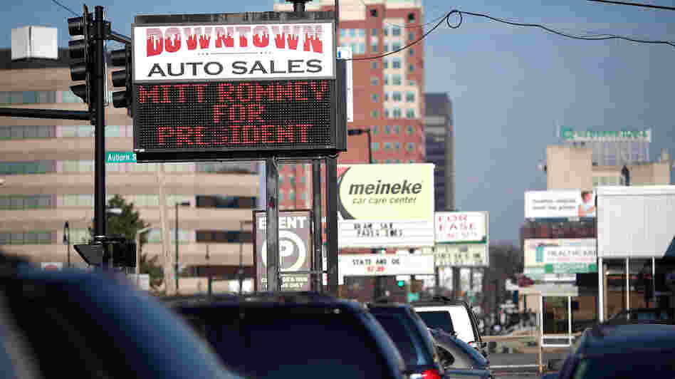 A used-car lot displays a sign in support of Republican presidential candidate Mitt Romney in Manchester, N.H., in January.