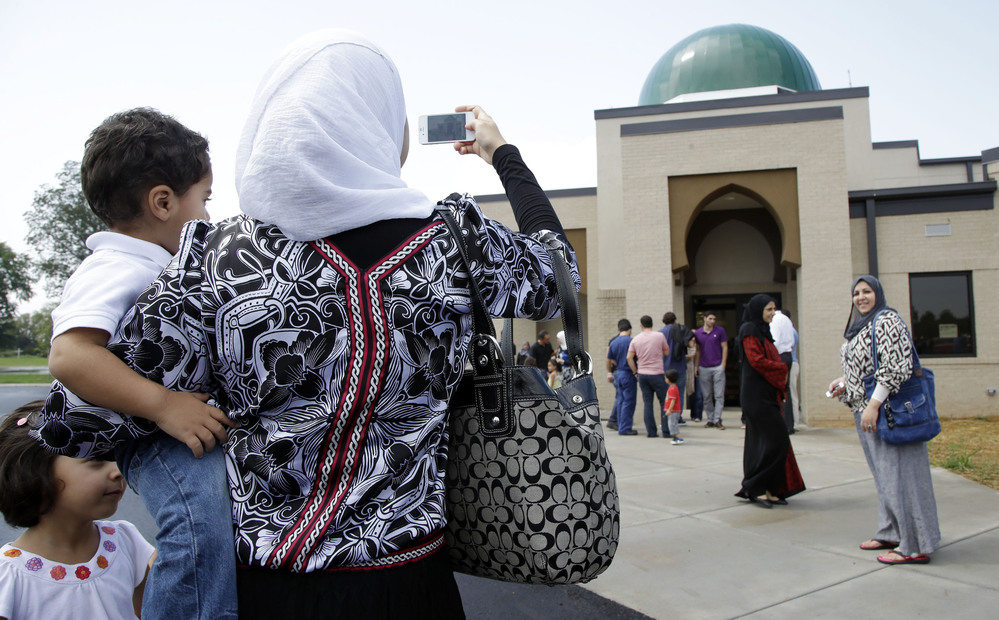 A woman takes a picture of the Islamic Center of Murfreesboro after midday prayers in August in Murfreesboro, Tenn. Opponents of the mosque waged a two-year court battle trying to keep it from opening.