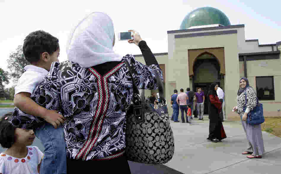 A woman takes a picture of the Islamic Center of Murfreesboro after midday prayers in August in Murfreesboro, Tenn. Opponents of the mosque waged a two-year court battle trying to keep it from opening.
