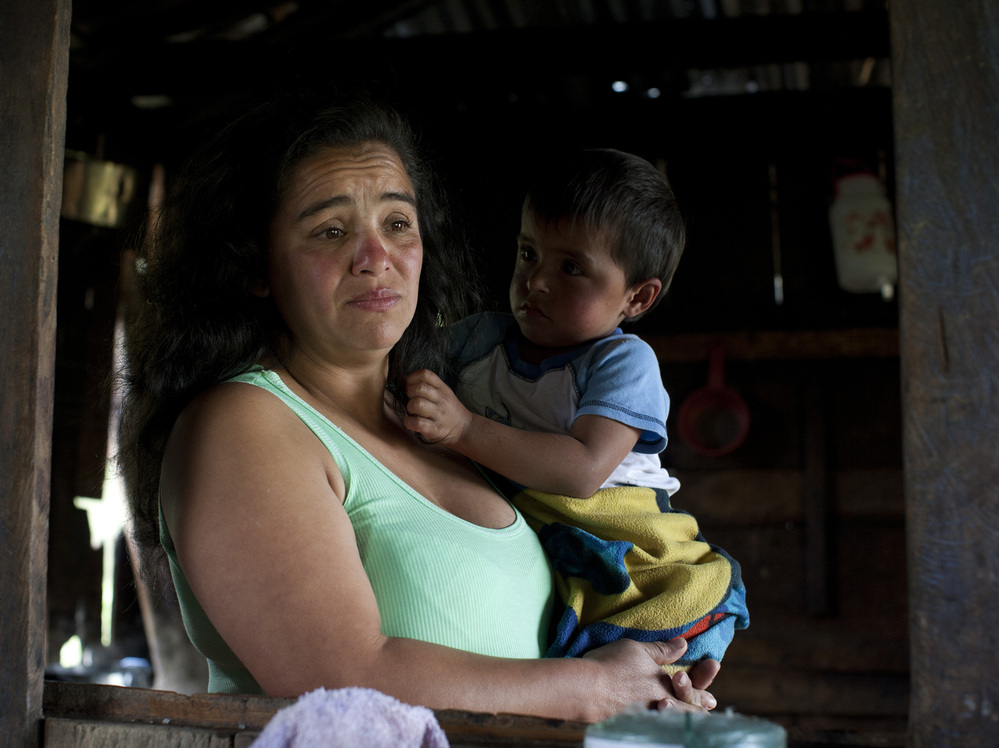 Nohemi Caicedo holds her grandson, Christian Camilo, in the kitchen of her home in Marquetalia, the birthplace of the FARC, in Colombia's Tolima state. Her 18-year-old son was killed in the insurgency after he was forcibly recruited to the FARC. She wants to give peace a chance, for the sake of her other children.