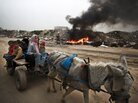 A Palestinian family rides on a donkey cart along a waste dump in Al-Nusirat, central Gaza Strip, in February. Living conditions continue to deteriorate for the 1.8 million Palestinians who reside in Gaza. A Palestinian family rides on a donkey cart along a waste dump in Al-Nusirat, central Gaza Strip, in February. Living conditions continue to deteriorate for the 1.8 million Palestinians who reside in Gaza.