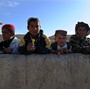 January 2011: Boys in the Andar district of Afghanistan gathered to collect candy from passing U.S. Army soldiers. Now, there are reports from that area of locals rising up against the Taliban.