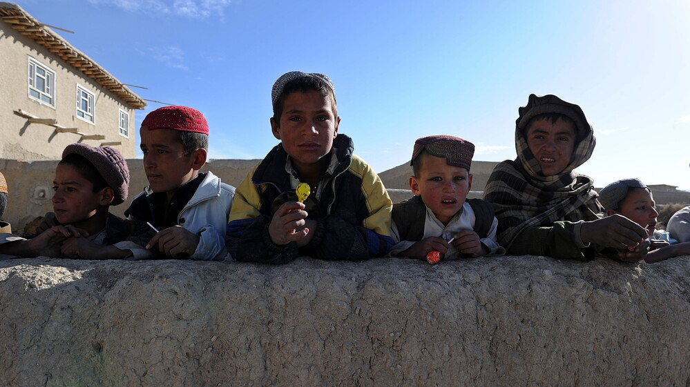 January 2011: Boys in the Andar district of Afghanistan gathered to collect candy from passing U.S. Army soldiers. Now, there are reports from that area of locals rising up against the Taliban.