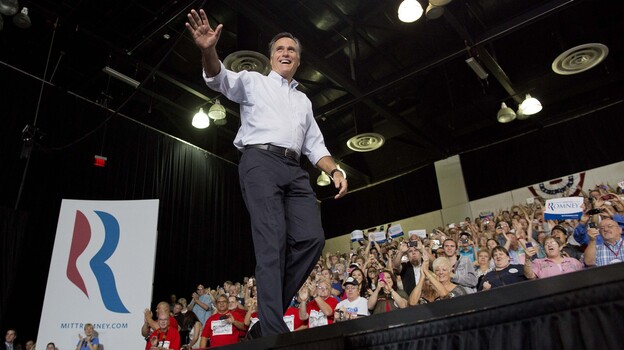 Mitt Romney waves to supporters as he arrives at a rally Friday in Las Vegas.