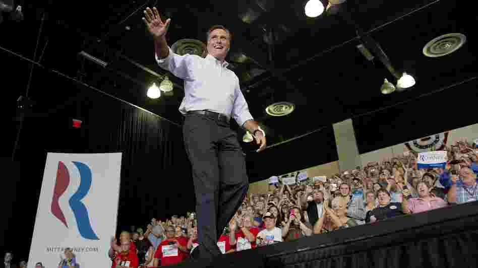 Mitt Romney waves to supporters as he arrives at a rally Friday in Las Vegas.