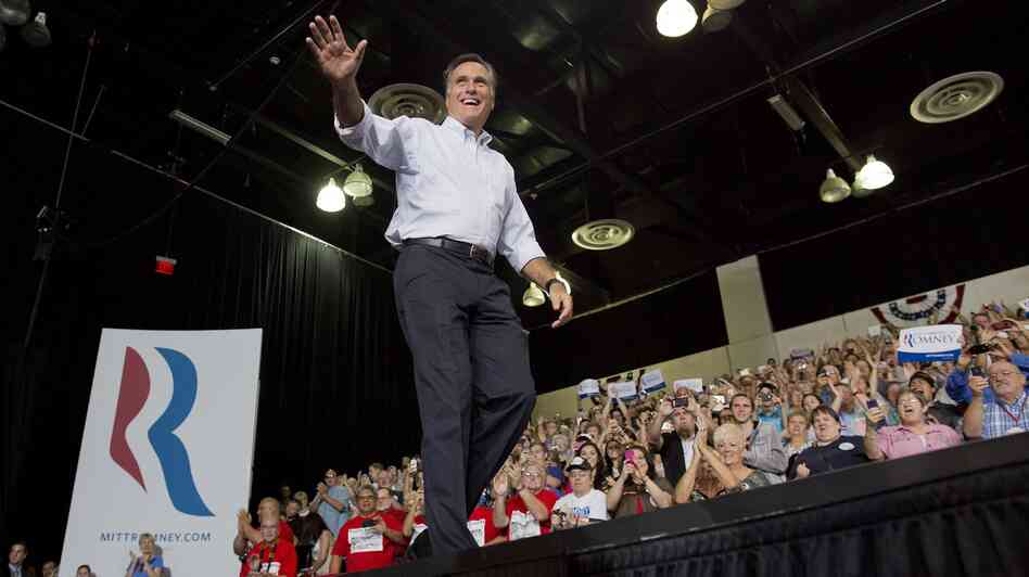 Mitt Romney waves to supporters as he arrives at a rally Friday in Las Vegas.