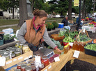 Heidi Accola works a stand at the farmers market in Baraboo, Wis. She runs a 1-acre organic farm with her husband, but she says they don't talk politics at home because it gets too heated. Heidi Accola works a stand at the farmers market in Baraboo, Wis. She runs a 1-acre organic farm with her husband, but she says they don't talk politics at home because it gets too heated.