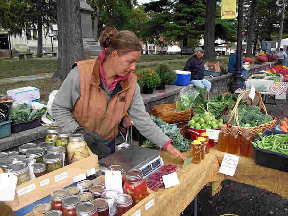 Heidi Accola works a stand at the farmers market in Baraboo, Wis. She runs a 1-acre organic farm with her husband, but she says they don't talk politics at home because it gets too heated.