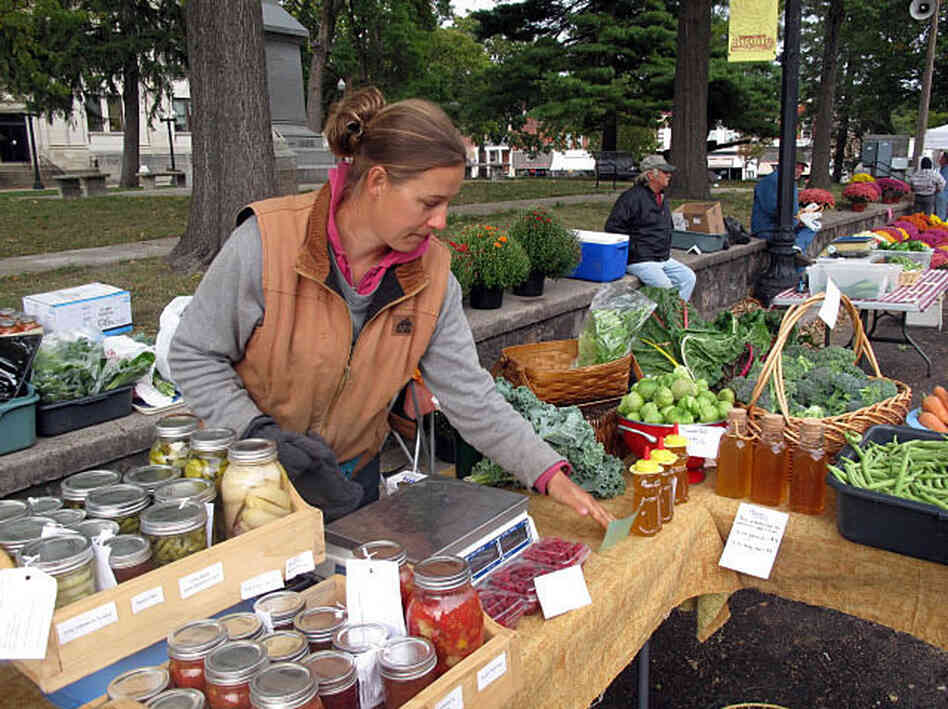 Heidi Accola works a stand at the farmers market in Baraboo, Wis. She runs a 1-acre organic farm with her husband, but she says they don't talk politics at home because it gets too heated.