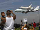 Spectators Mario Vasquez, 40, of Redondo Beach and his son Mario Jr., 2, watch as space shuttle Endeavour, atop NASA's Shuttle Carrier Aircraft, prepares to land at Los Angeles International Airport Friday.