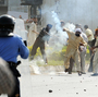 In Islamabad today, this demonstrator threw a tear gas canister back toward police.