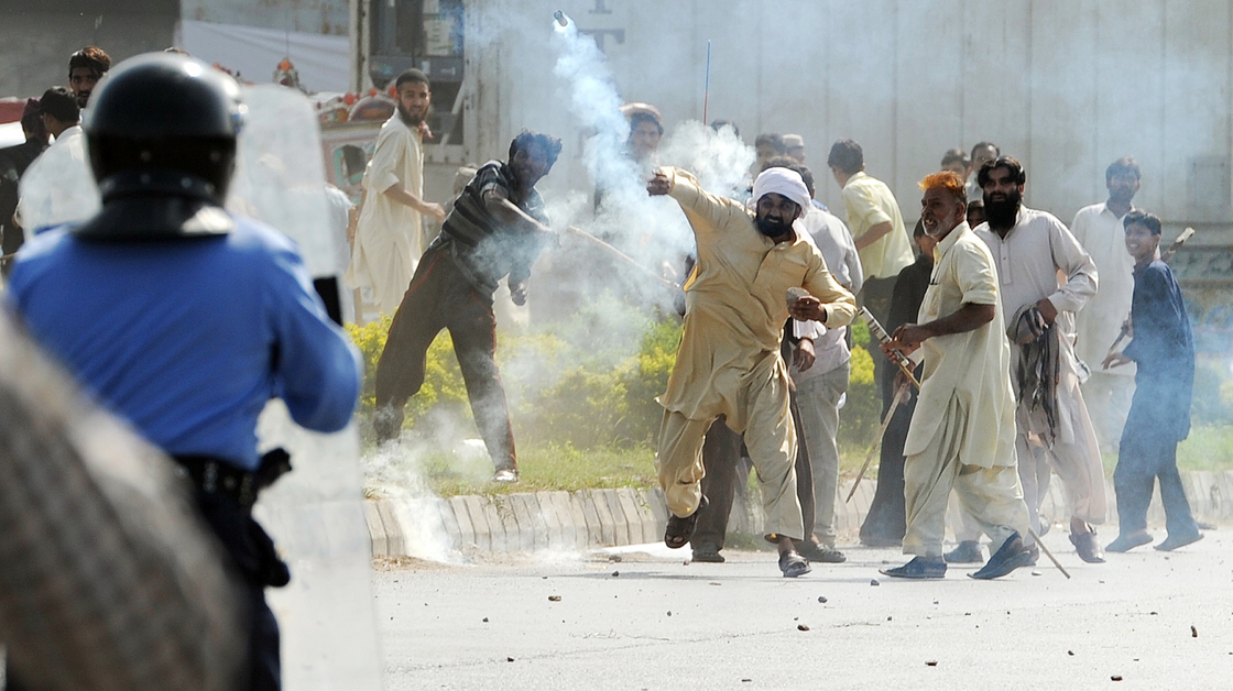 In Islamabad today, this demonstrator threw a tear gas canister back toward police.