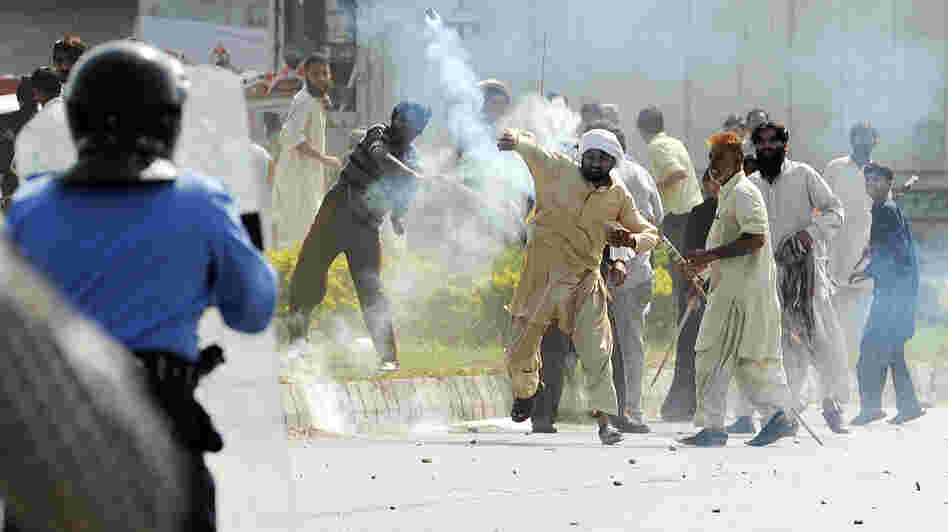 In Islamabad today, this demonstrator threw a tear gas canister back toward police.