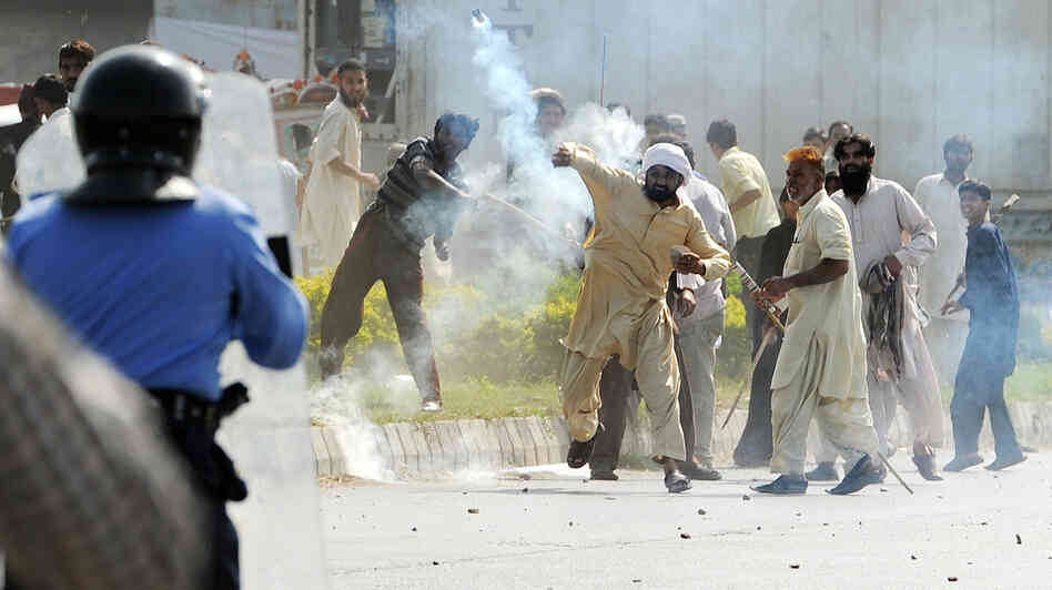 In Islamabad today, this demonstrator threw a tear gas canister back toward police.