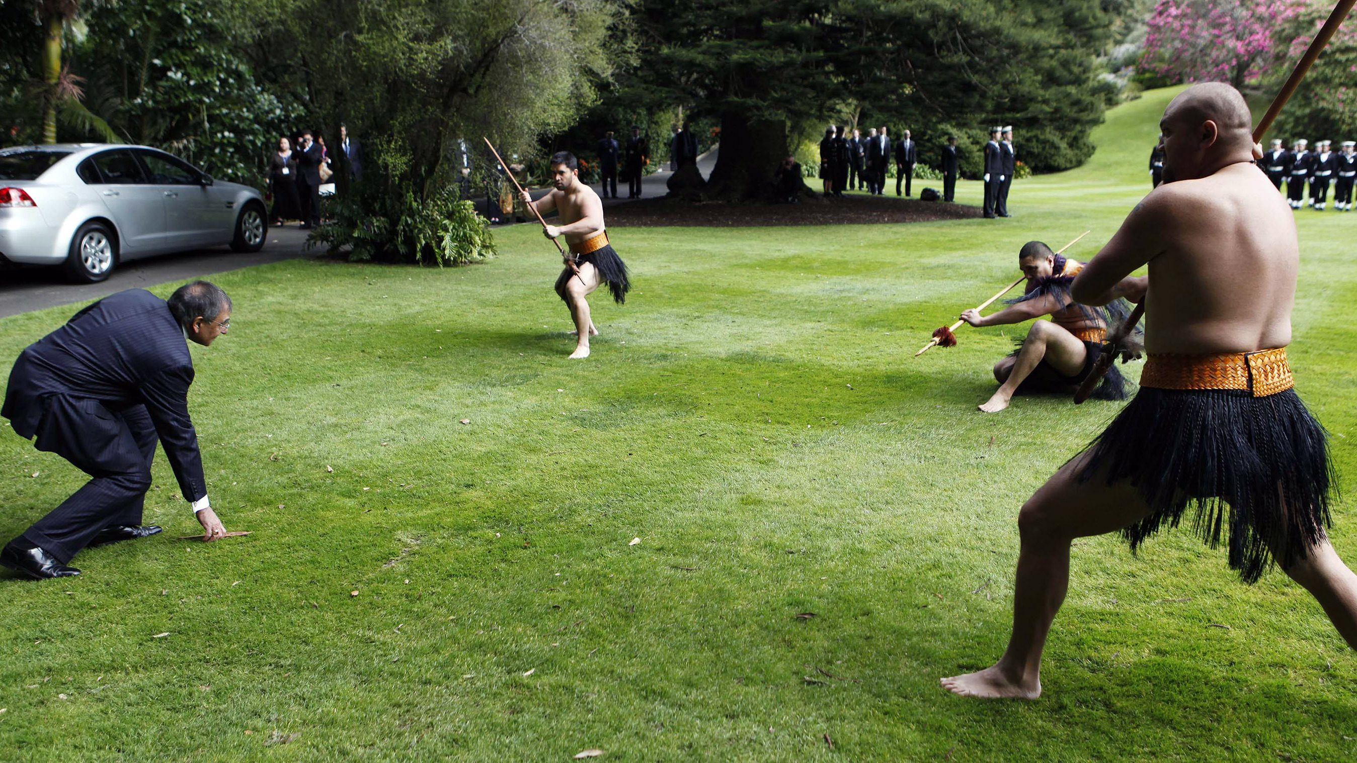 U.S. Defense Secretary Leon Panetta, left, picks up a dart during a Maori welcome ceremony at the Government House in Auckland, New Zealand on Friday.
