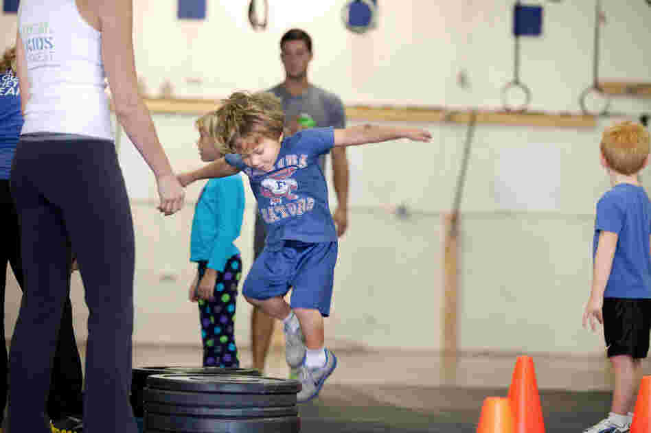 Evan Ciangiulli, 4, hops onto a stack of weights as part of his CrossFit training in Rockville, Md.