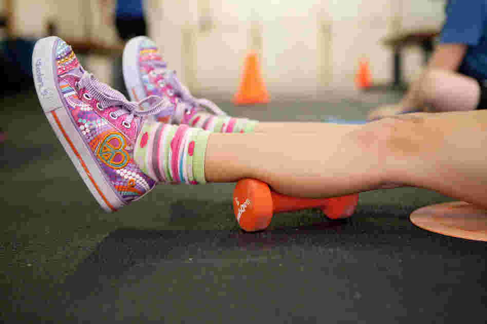 Simara Decker, 6, relaxes before beginning her weightlifting exercise.