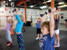Evan Ciangiulli, 4, completes a warmup that teaches him the right way to lift weights. Evan Ciangiulli, 4, completes a warmup that teaches him the right way to lift weights.