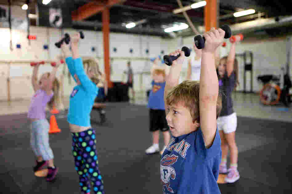 Evan Ciangiulli, 4, completes a warmup that teaches him the right way to lift weights.
