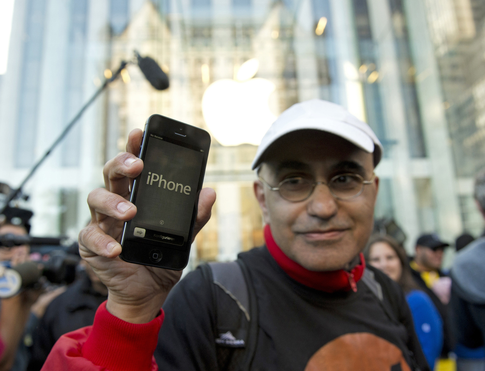 Hazem Sayed exits the Apple store on Fifth Avenue after purchasing his new iPhone 5.