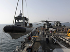 A U.S. Navy boat is lowered to the sea from the deck of the USS Ponce in the Persian Gulf on Sept. 22. More than 30 nations are participating in an exercise responding to simulated sea-mine attacks in international waters amid rising tension with Iran. A U.S. Navy boat is lowered to the sea from the deck of the USS Ponce in the Persian Gulf on Sept. 22. More than 30 nations are participating in an exercise responding to simulated sea-mine attacks in international waters amid rising tension with Iran.