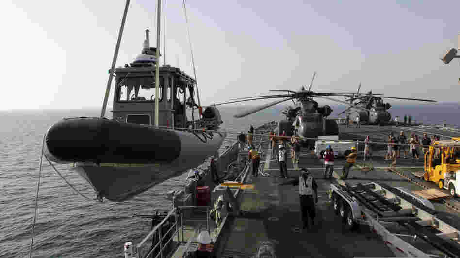 A U.S. Navy boat is lowered to the sea from the deck of the USS Ponce in the Persian Gulf on Sept. 22. More than 30 nations are participating in an exercise responding to simulated sea-mine attacks in international waters amid rising tension with Iran. A U.S. Navy boat is lowered to the sea from the deck of the USS Ponce in the Persian Gulf on Sept. 22. More than 30 nations are participating in an exercise responding to simulated sea-mine attacks in international waters amid rising tension with Iran.