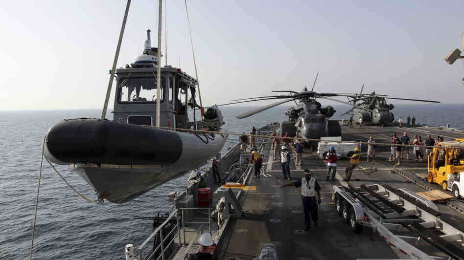 A U.S. Navy boat is lowered to the sea from the deck of the USS Ponce in the Persian Gulf on Sept. 22. More than 30 nations are participating in an exercise responding to simulated sea-mine attacks in international waters amid rising tension with Iran. A U.S. Navy boat is lowered to the sea from the deck of the USS Ponce in the Persian Gulf on Sept. 22. More than 30 nations are participating in an exercise responding to simulated sea-mine attacks in international waters amid rising tension with Iran.