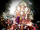 At left, one of the many processions of Lord Ganesh; at right a woman decorates her hair with fresh jasmine.