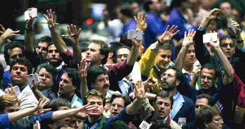 Traders work in the bond pit at the Chicago Board of Trade in 1995. In recent decades, much of the trading has left the pits and gone electronic.